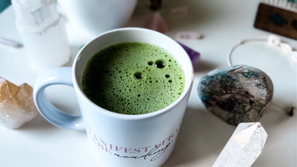 Frothy green uji ceremonial grade matcha in a white cup